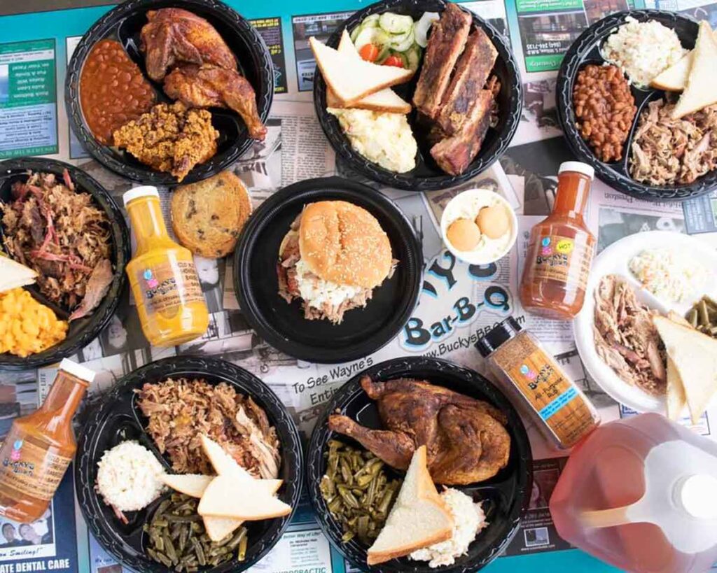 Table full of all the meats and sides served at Bucky's BBQ.