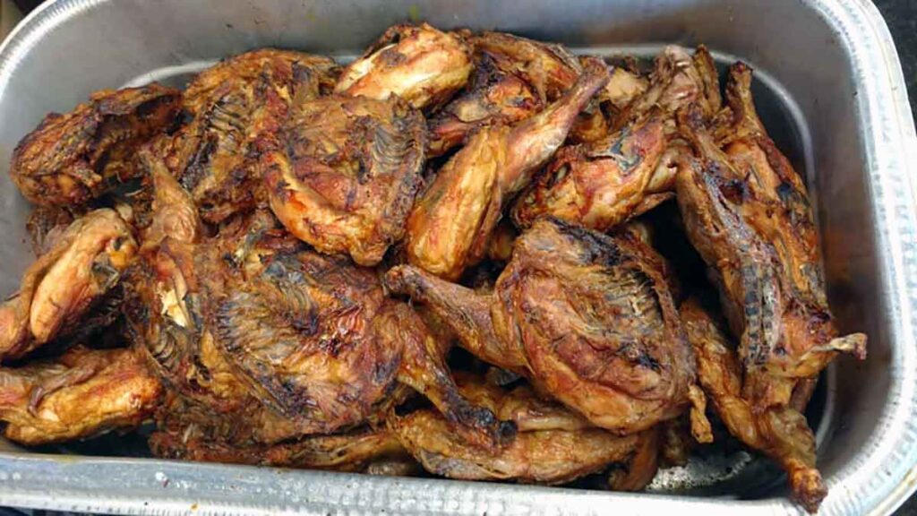 Barbecued chickens (unsuaced) in food bin