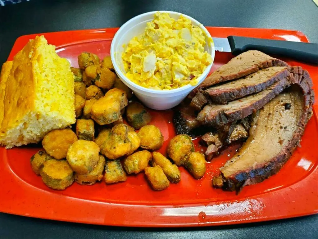 Brisket plate with cornbread, fried okra, and potato salad