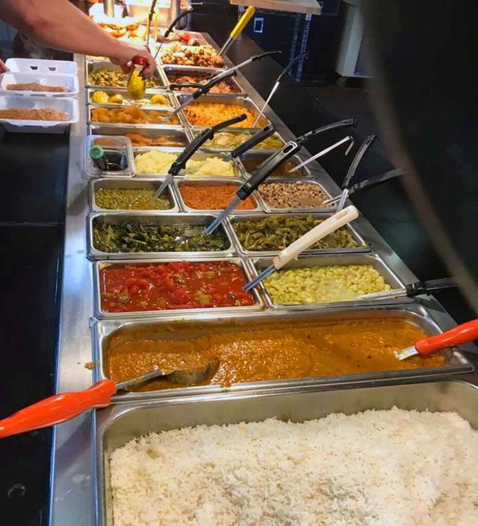 Trays of hash, rice, and veggies on buffet