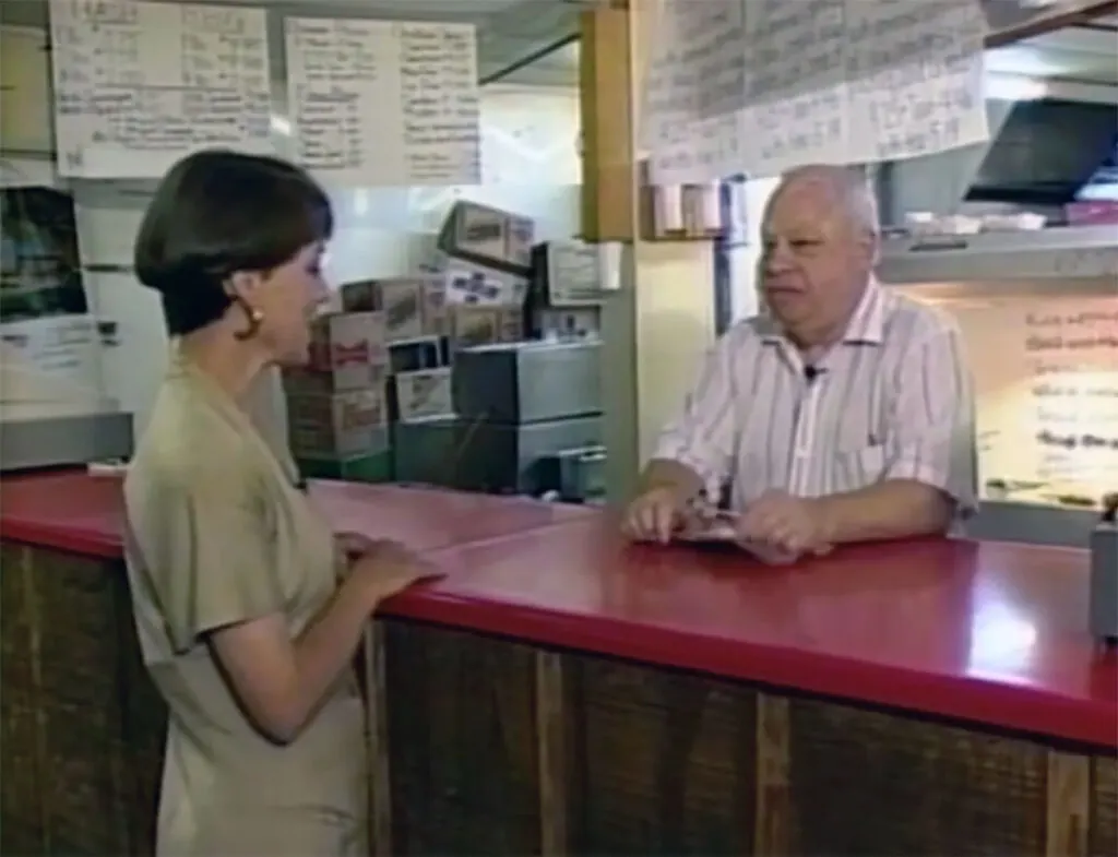 Jack O'Dell founder of Midway BBQ serving a customer