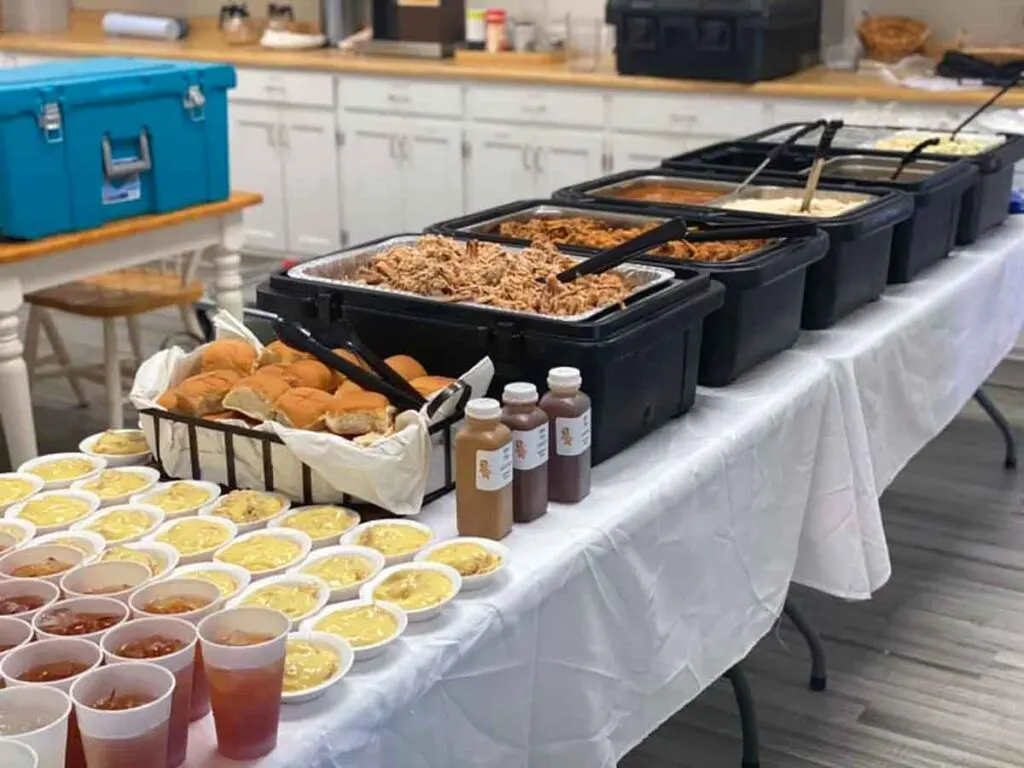 Assortment of food and drink set out on table at a event Little Pigs was catering