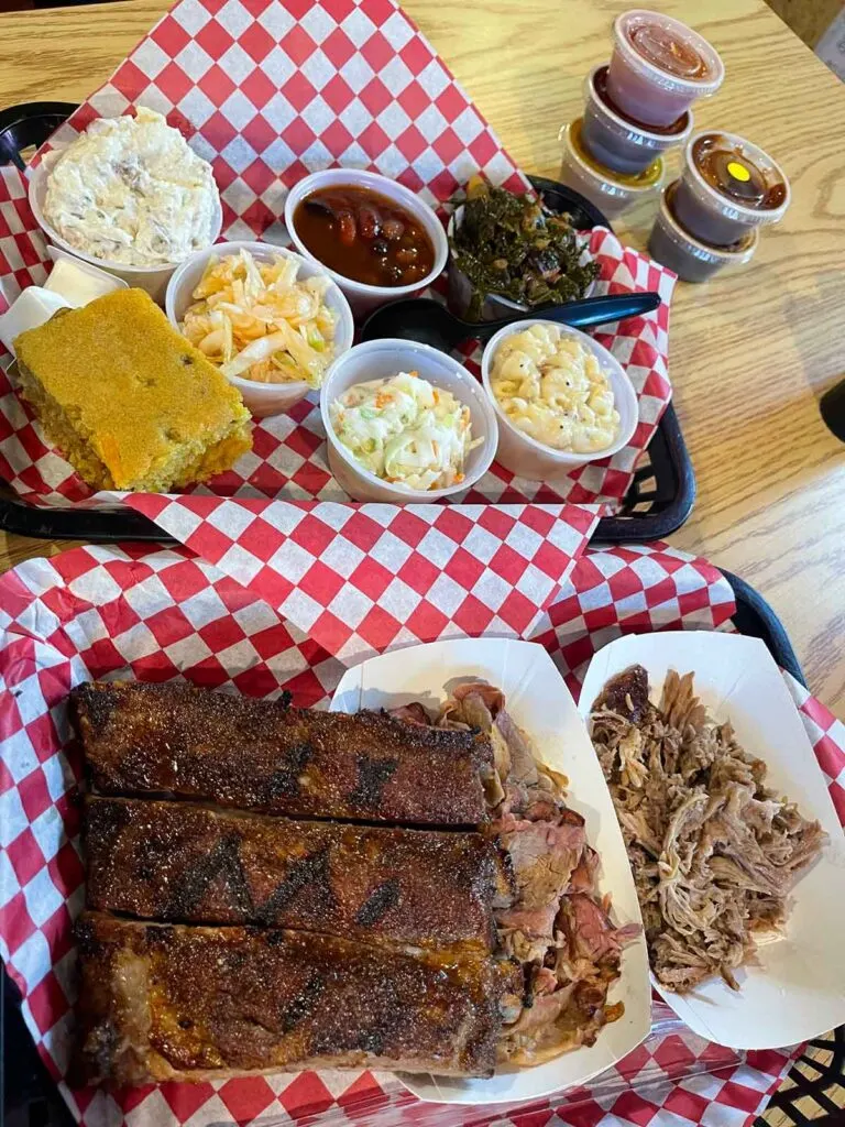 Two trays full of many of the meat and sides offerings at Bullies BBQ.