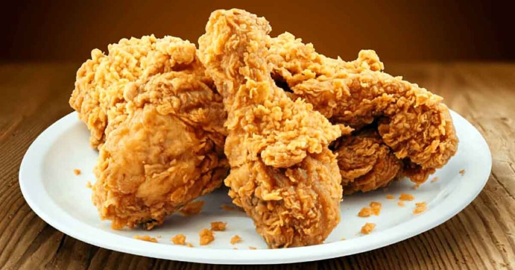 Several pieces of fried chicken on a plate.
