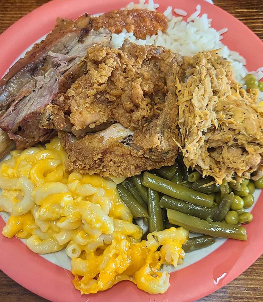 Plate full of barbecue, chicken, and sides from Music Man's.