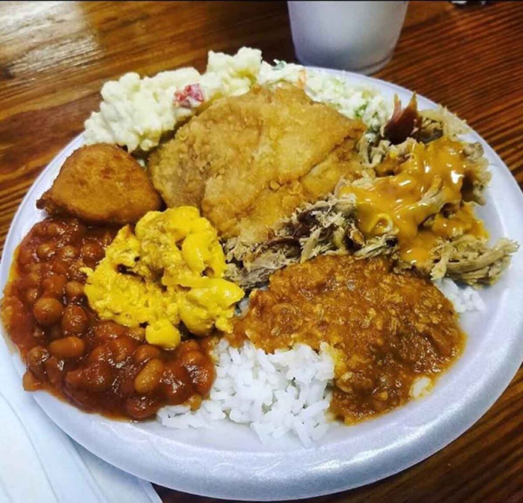 BBQ, hash, fried chicken and sides on styrofoam plate