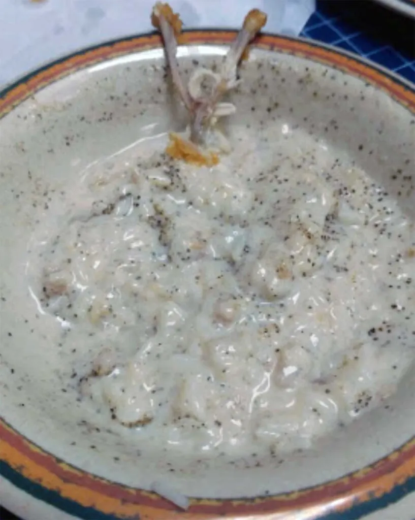 Pulley bone remnants in bowl of milk gravy