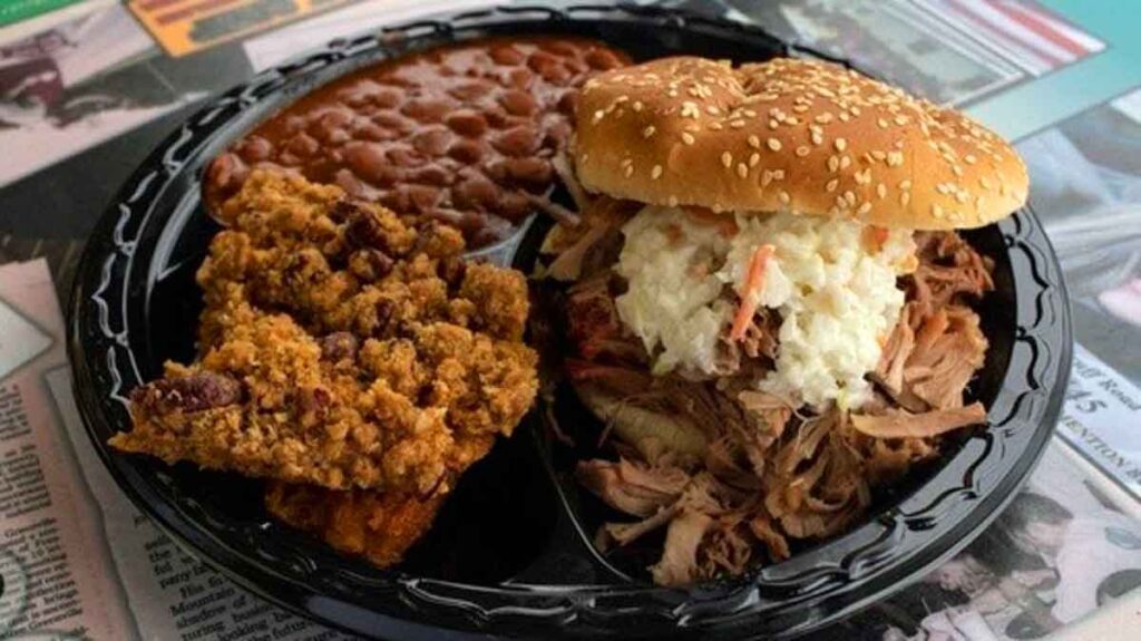 BBQ sandwich with slaw on top and sides.