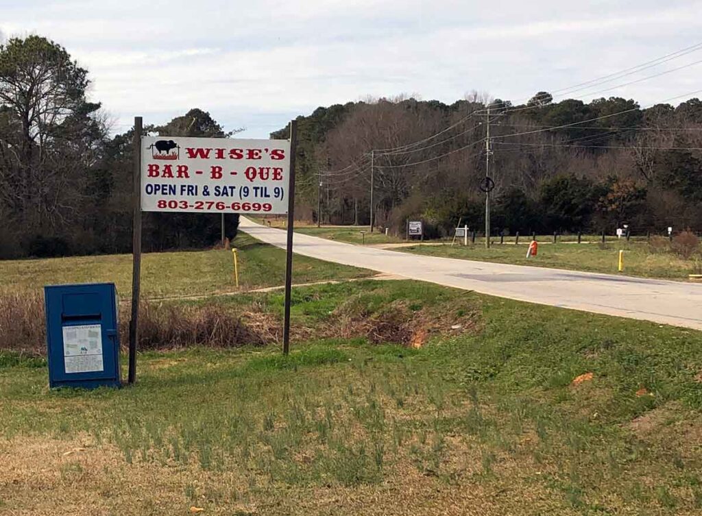 Sign by road for Wise's BBQ