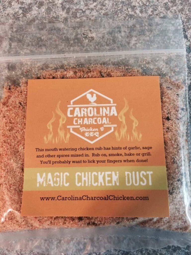 Zip-top bag labeled Carolina Charcoal Rubs Carolina Chicken Dust sitting on a black surface.