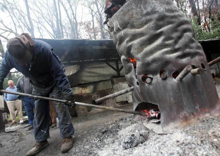 Gathering embers from the burn barrel at Scott's BBQ Hemingway