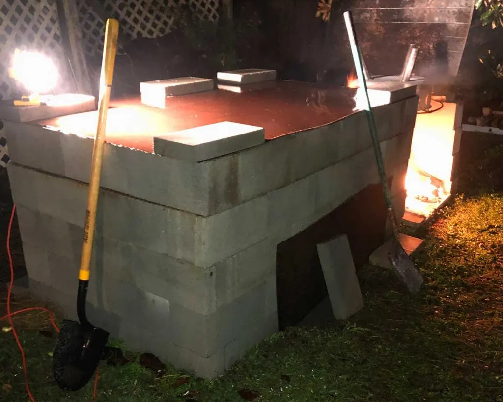 Roller family's backyard pit with fire pit beside it.