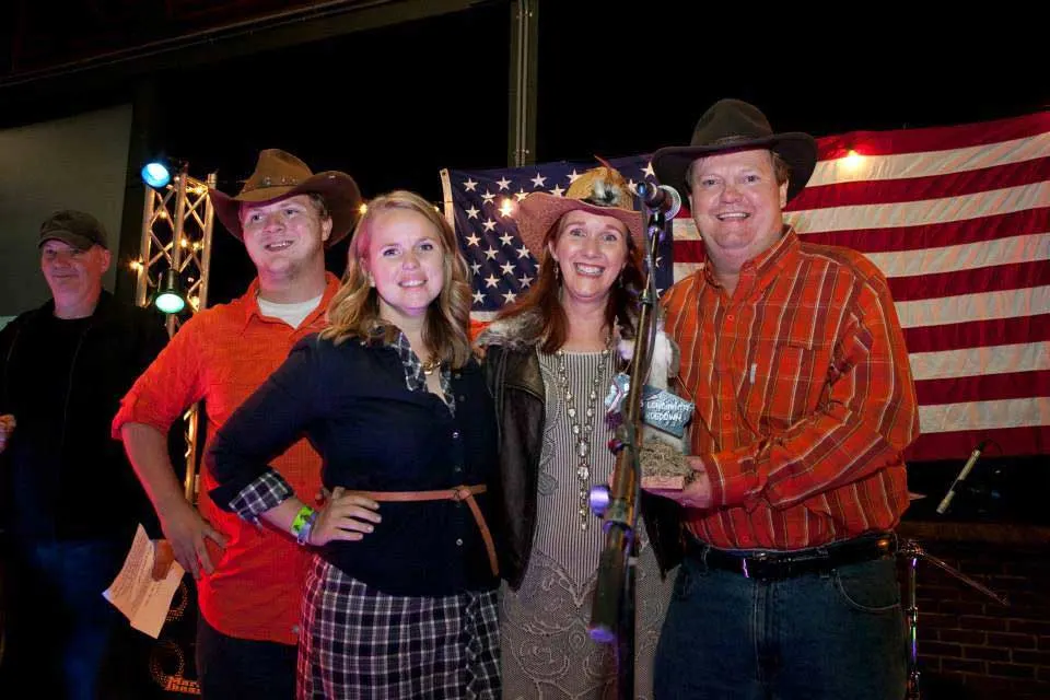 Greg Howard and family on stage holding an award