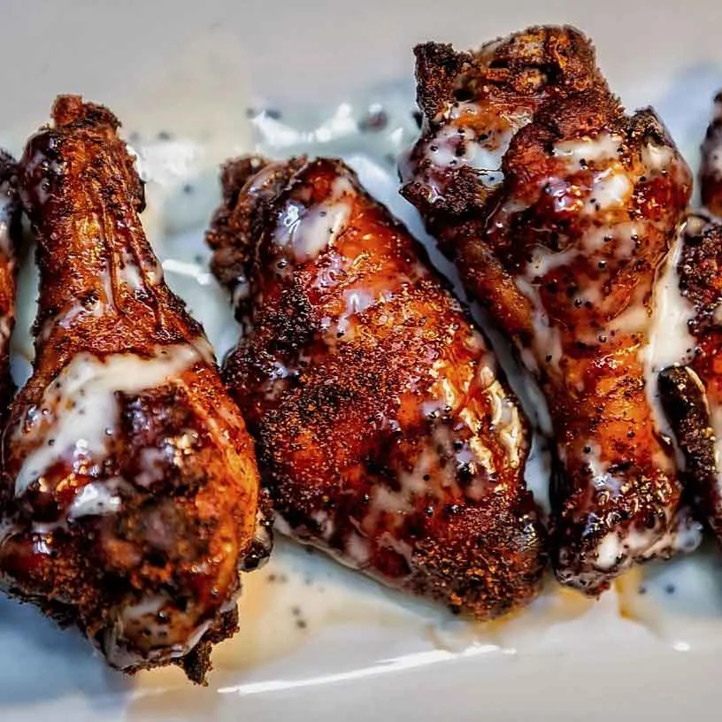 Three smoked wings in Alabama White sauce