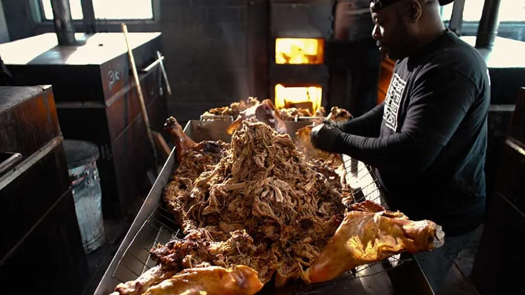 Rodney Scott pulling pork from whole hog