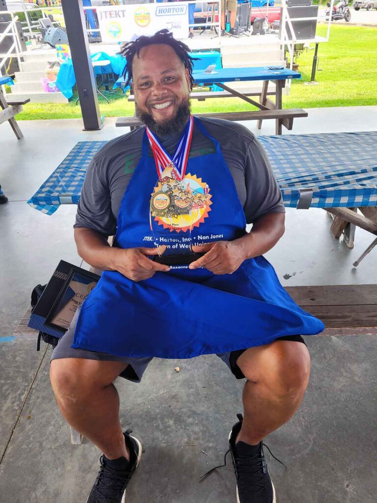 Delanio Taylor, owner of Big D's House of BBQ, with his competition BBQ awards
