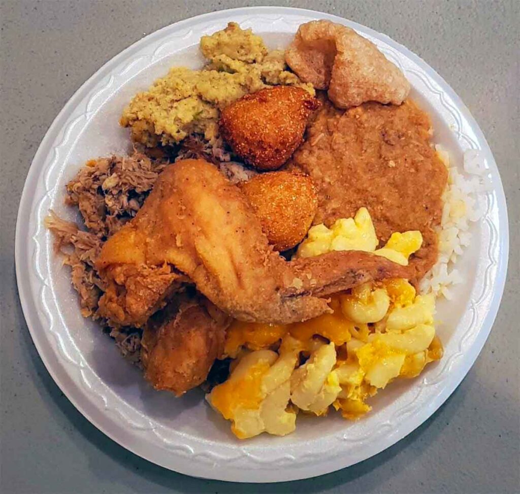 Round plate full of barbecue, hash and sides