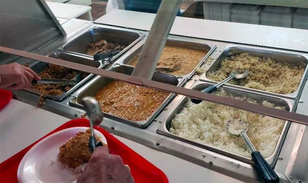 Buffet line filled with Lester's BBQ, hash and rice