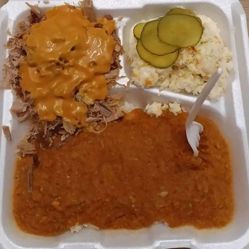 Styrofoam tray with red hash, bbq covered in rust gravy, and slaw from Dukes on Chestnut in Orangeburg.
