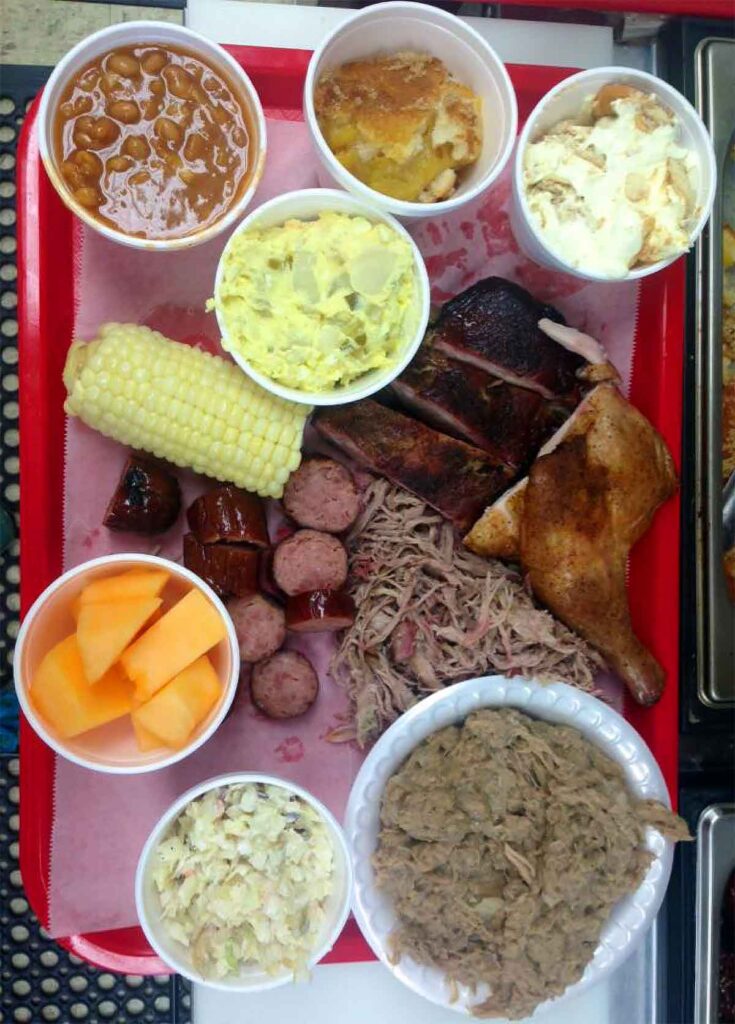 One of everything on Fat Daddy's menu sitting on in containers or on red plastic serving tray.
