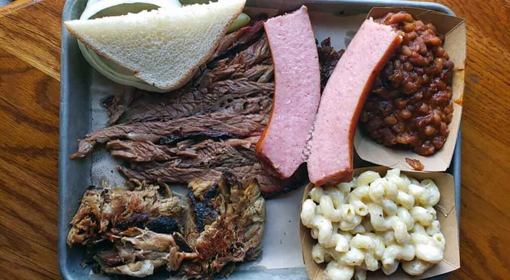 Meats, beans, mac and cheese with bread.