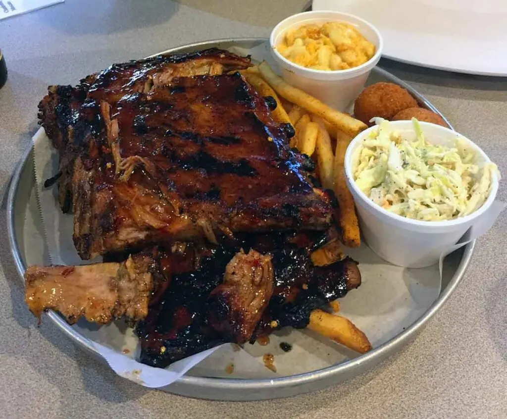 Plate with ribs, fries, slaw, and Mac n cheese.