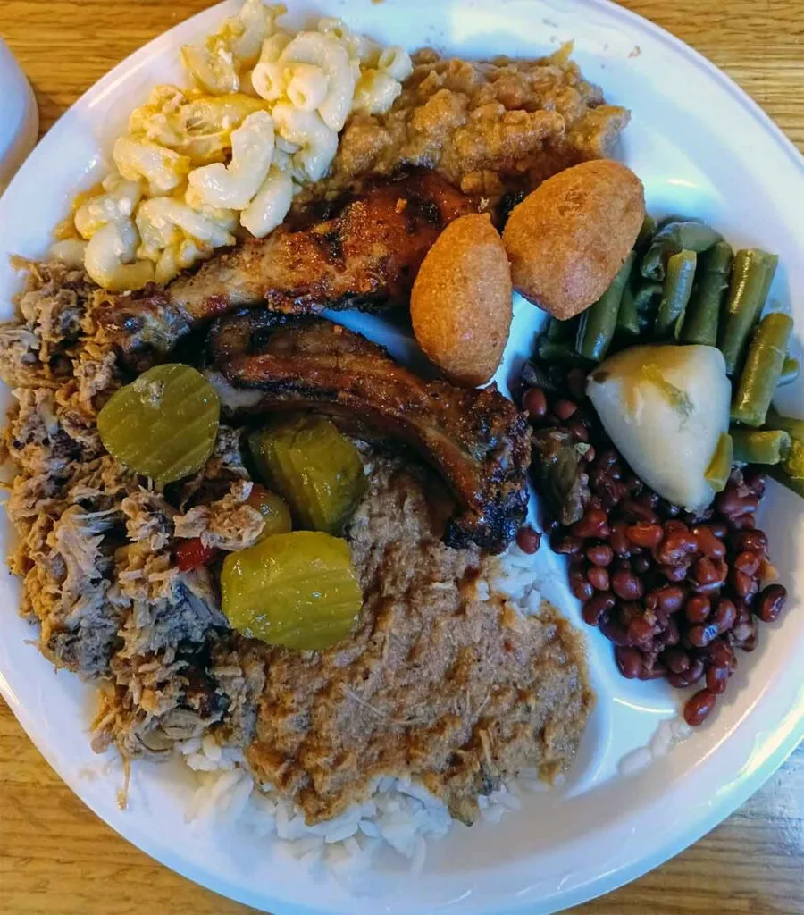 Plate of BBQ with ribs, hash and sides.
