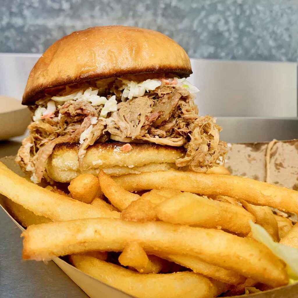 BBQ sandwich with slaw and fries.