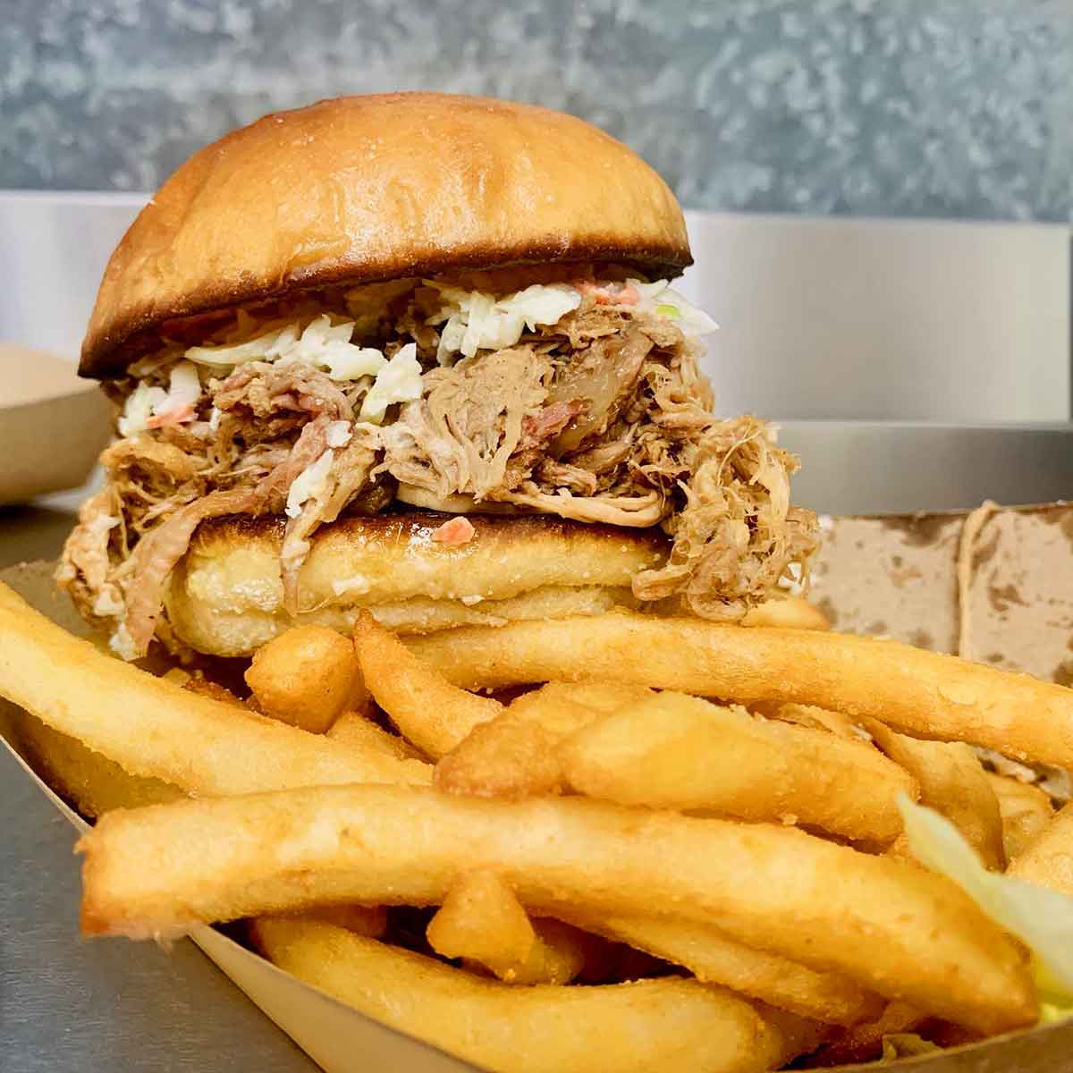 BBQ sandwich with slaw and fries.