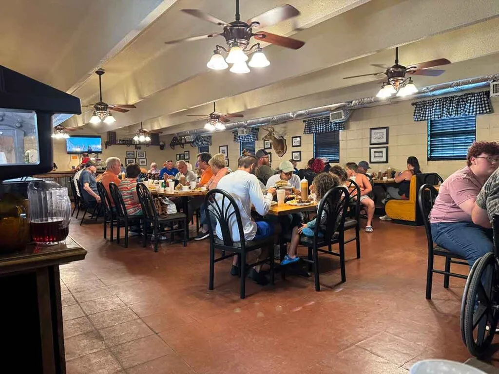 Interior of Westwood BBQ, full of customers seated at tables.
