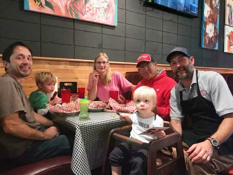 Chris Reeder greeting a Family dining at Fat Daddy's