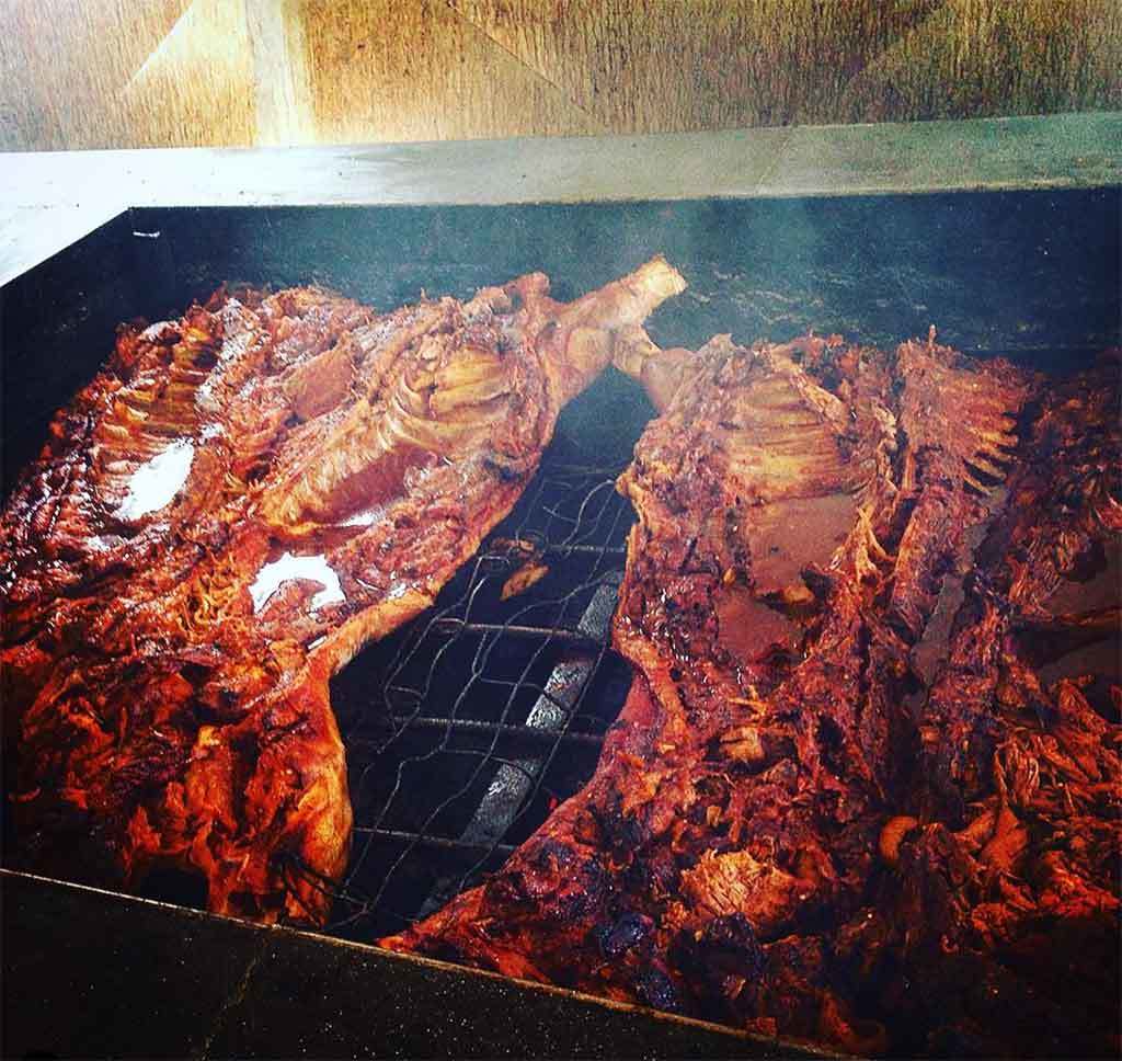 Whole hogs smoking on the Pit at Scott's BBQ Hemingway