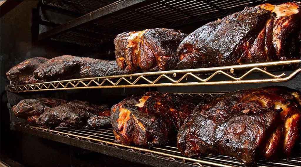 Pork smoking on the rotisserie at Roger’s Bar-B-Q House