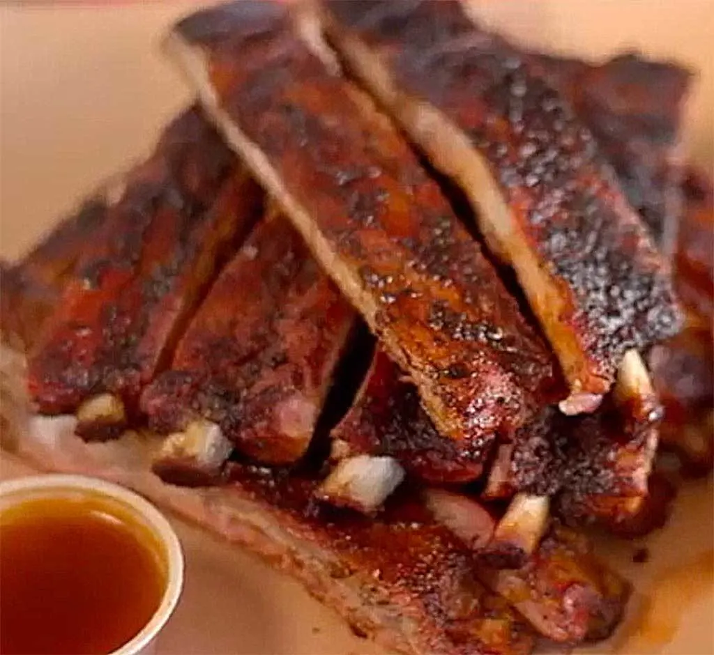  Bones protruding on a finished rack of Rodney Scott's BBQ ribs