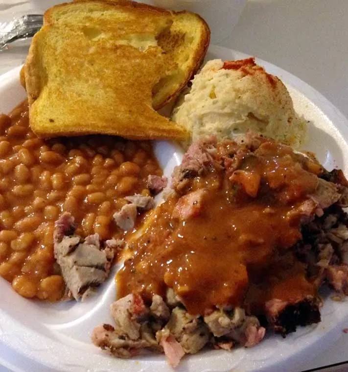 Chopped Barbecue Plate with beans, toast, and potato salad.