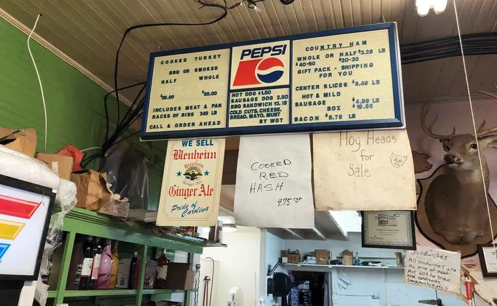 Menu hanging over meat case at Cooper's