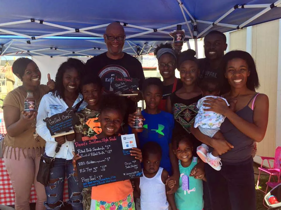 Roosevelt Durant and family with customers at his former roadside tent