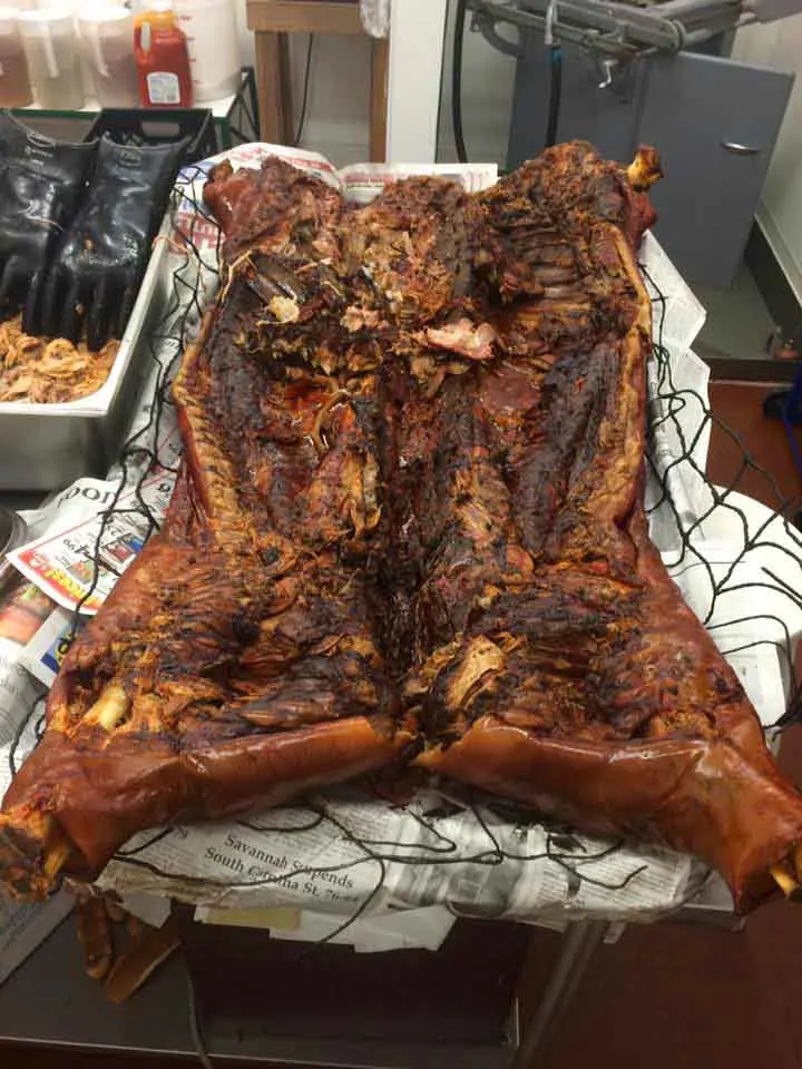 Whole hog on wire mesh and newspaper inside Cooper's Country Store.