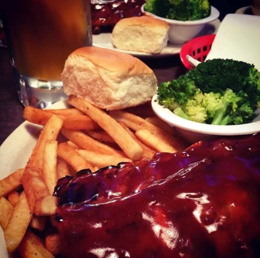 Sardis Den BBQ Ribs with fries, roll, and broccoli.