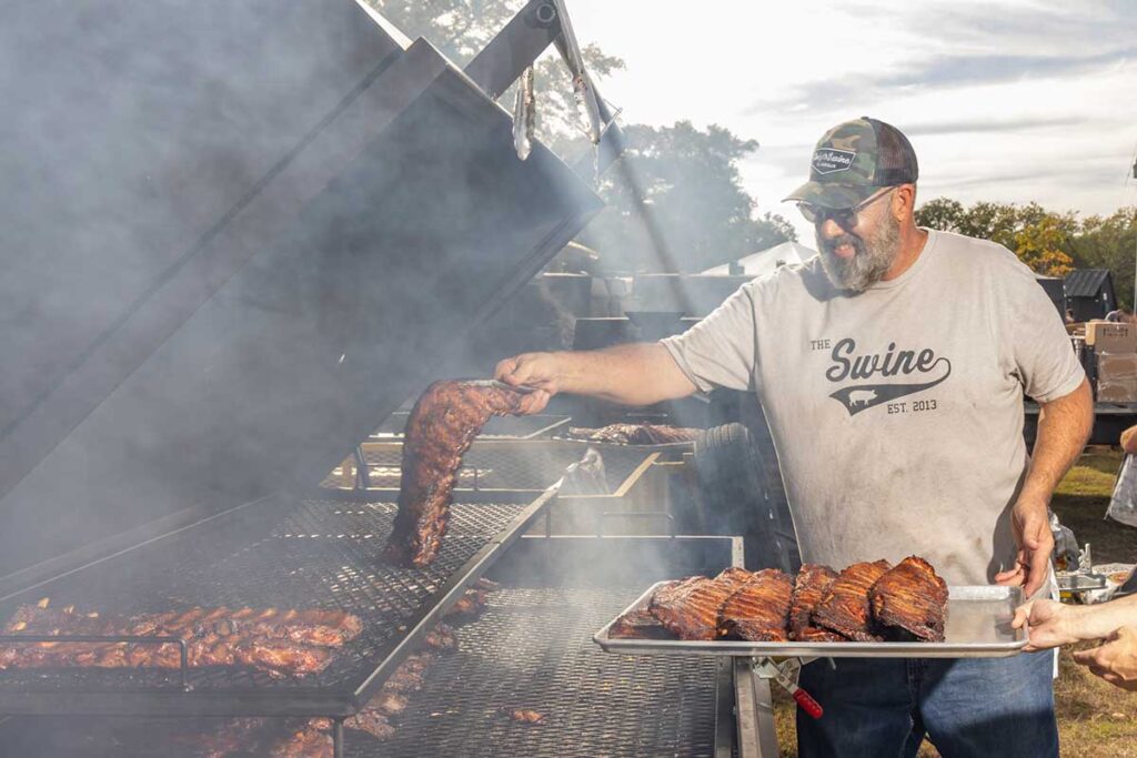 Anthony DiBernardo pulling ribs off pit