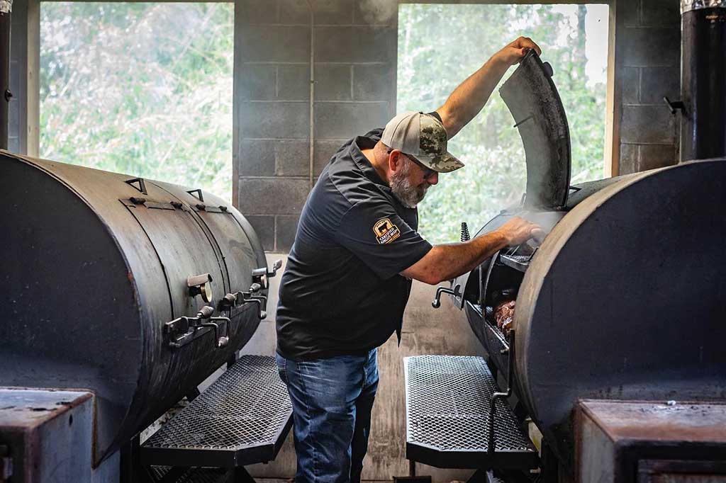 Owner Anthony DiBernardo working the pits at Swig and Swine