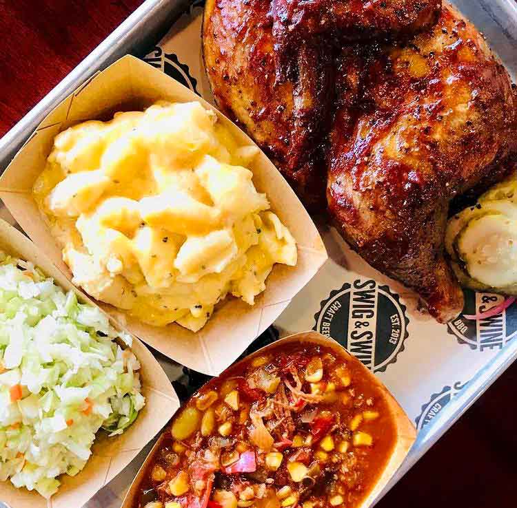 Half chicken in red sauce with 3 sides: slaw, Mac and cheese, Brunswick Stew.