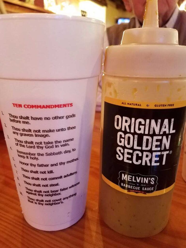 Cup with Ten Commandments printed on it and Mustard sauce bottle from Melvin’s Legendary Bar-B-Que