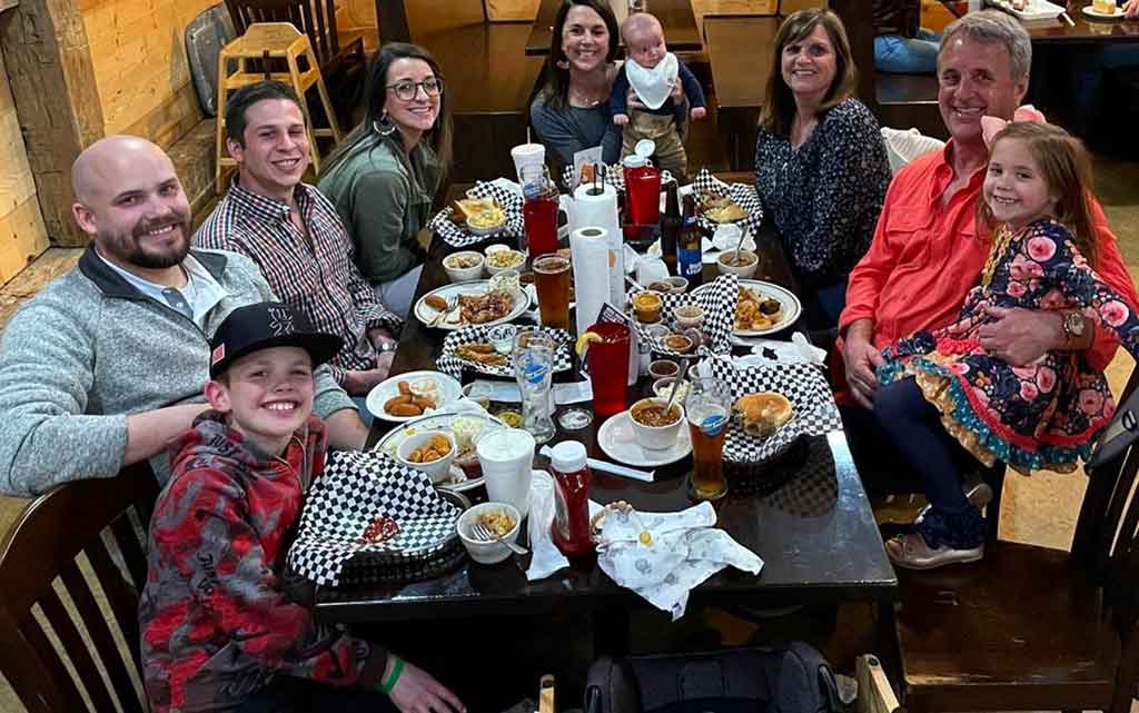 Large family gathered around a table at Sweet Caroline's