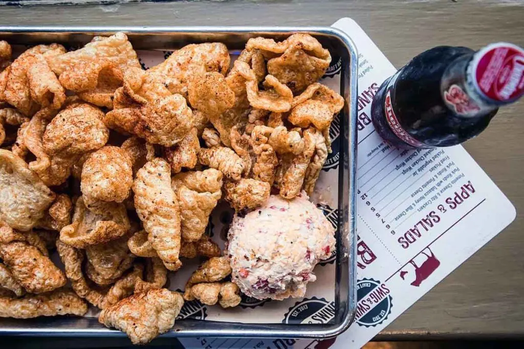 Pork rinds, pimento cheese and Cheerwine bottle
