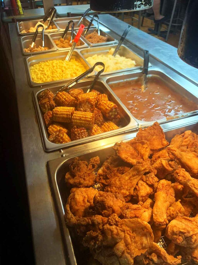 Buffet line at Poston's BBQ in Chesterfield with fried chicken, corn on the cob and other sides.