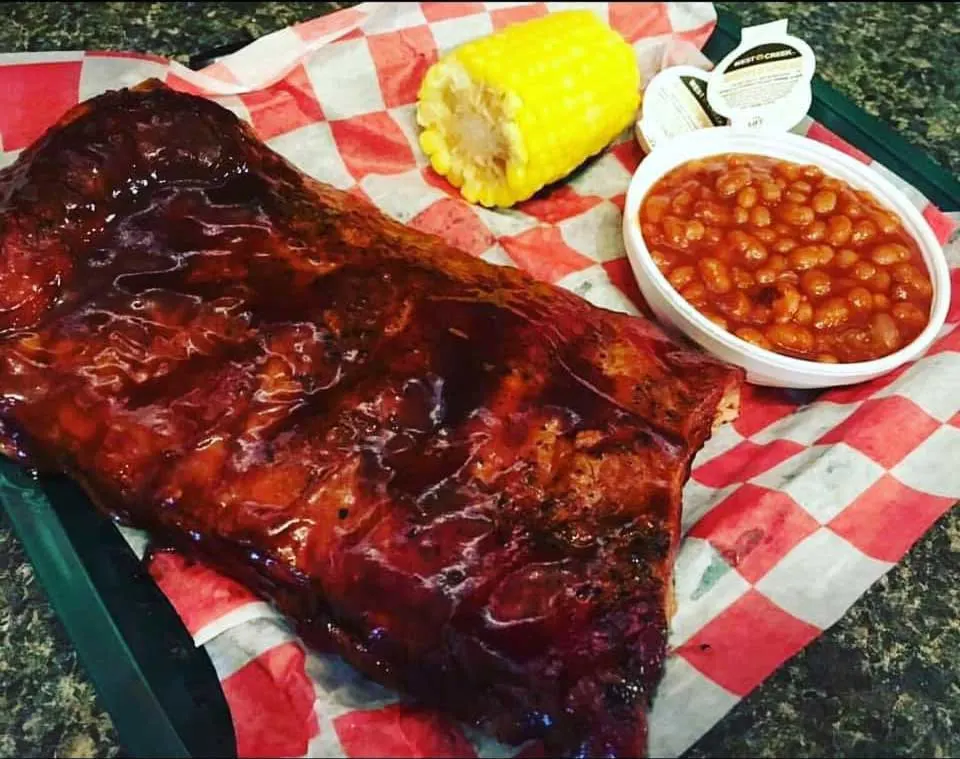 Glazed ribs with a side of corn on the cob and baked beans