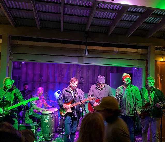 Shonuff playing on the stage at Home Team BBQ in Downtown Charleston.