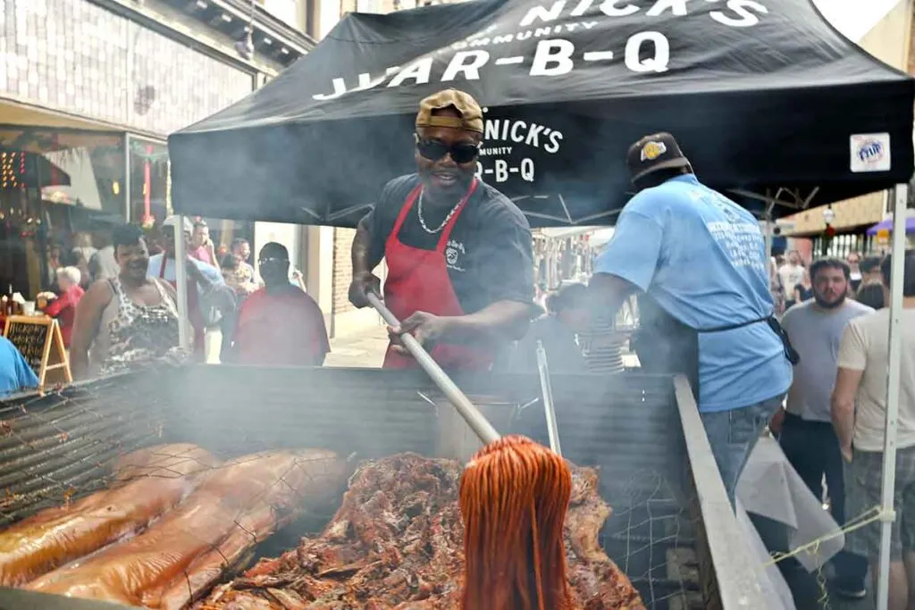 Rodney Scott mopping a whole hog with his vinegar-pepper barbecue sauce