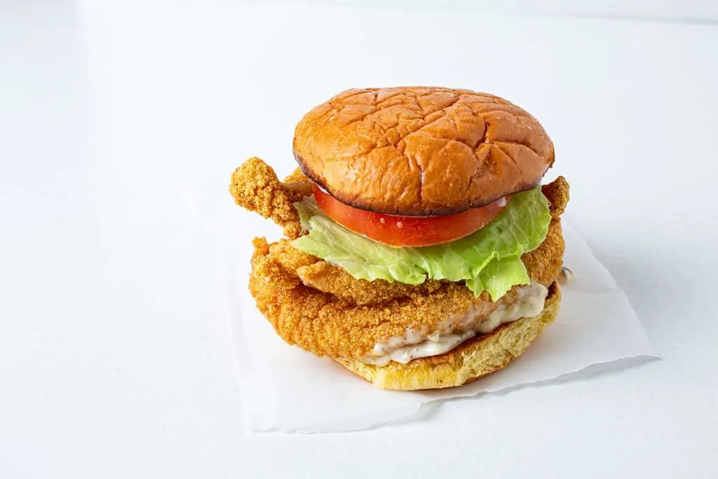 Rodney Scott's fried catfish sandwich with lettuce and tomato.